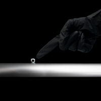 hand pointing to frame, frame detail, glove, close up frame